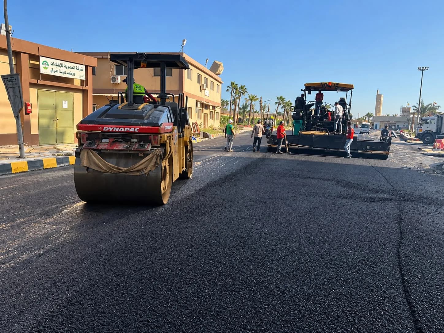 Paver and roller at work