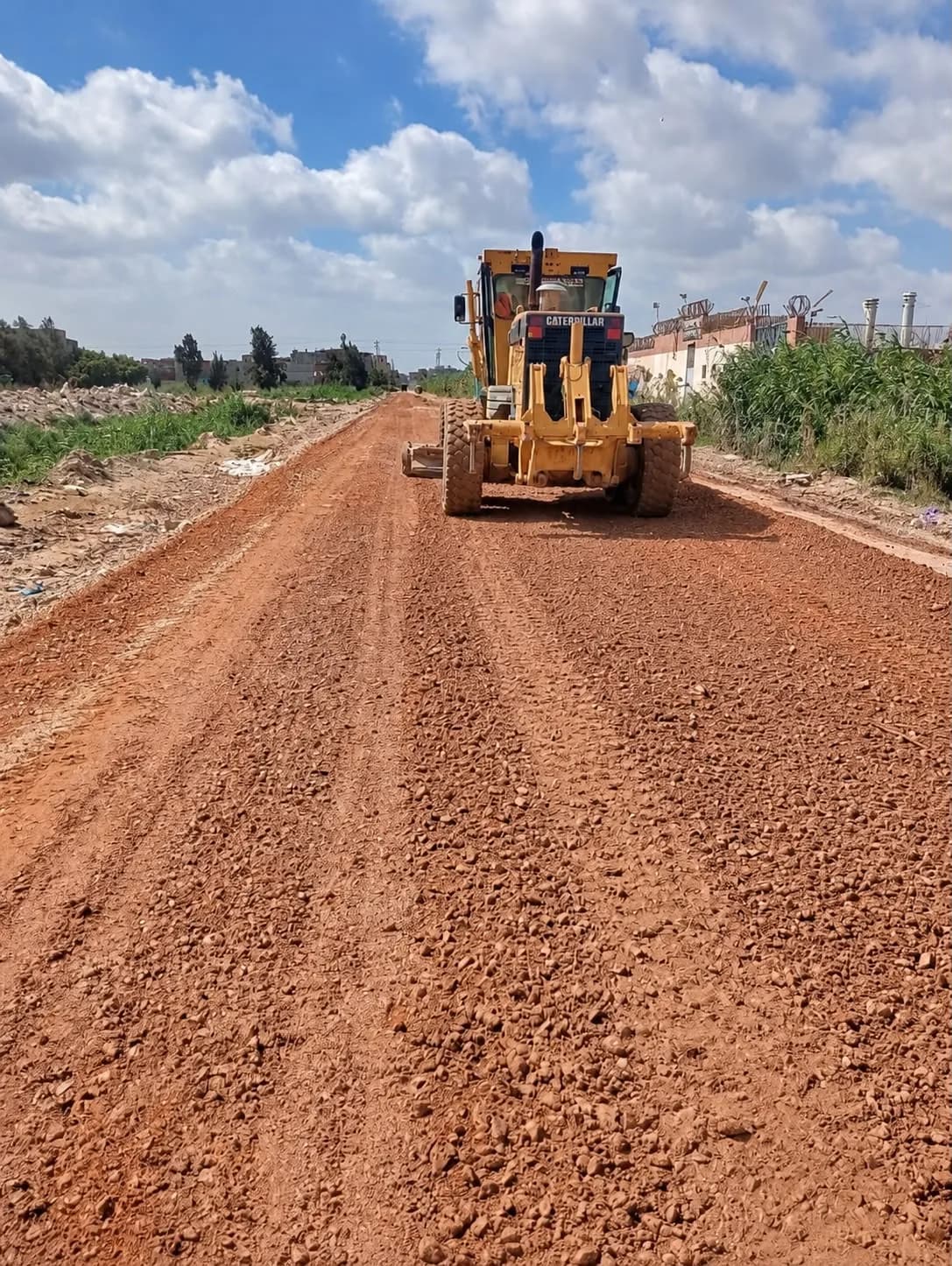 Grader spreading the base course