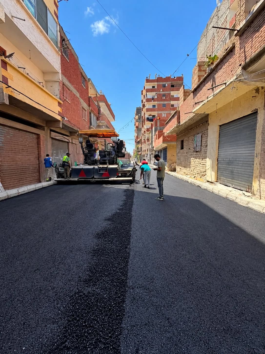 Paver laying asphalt in the district